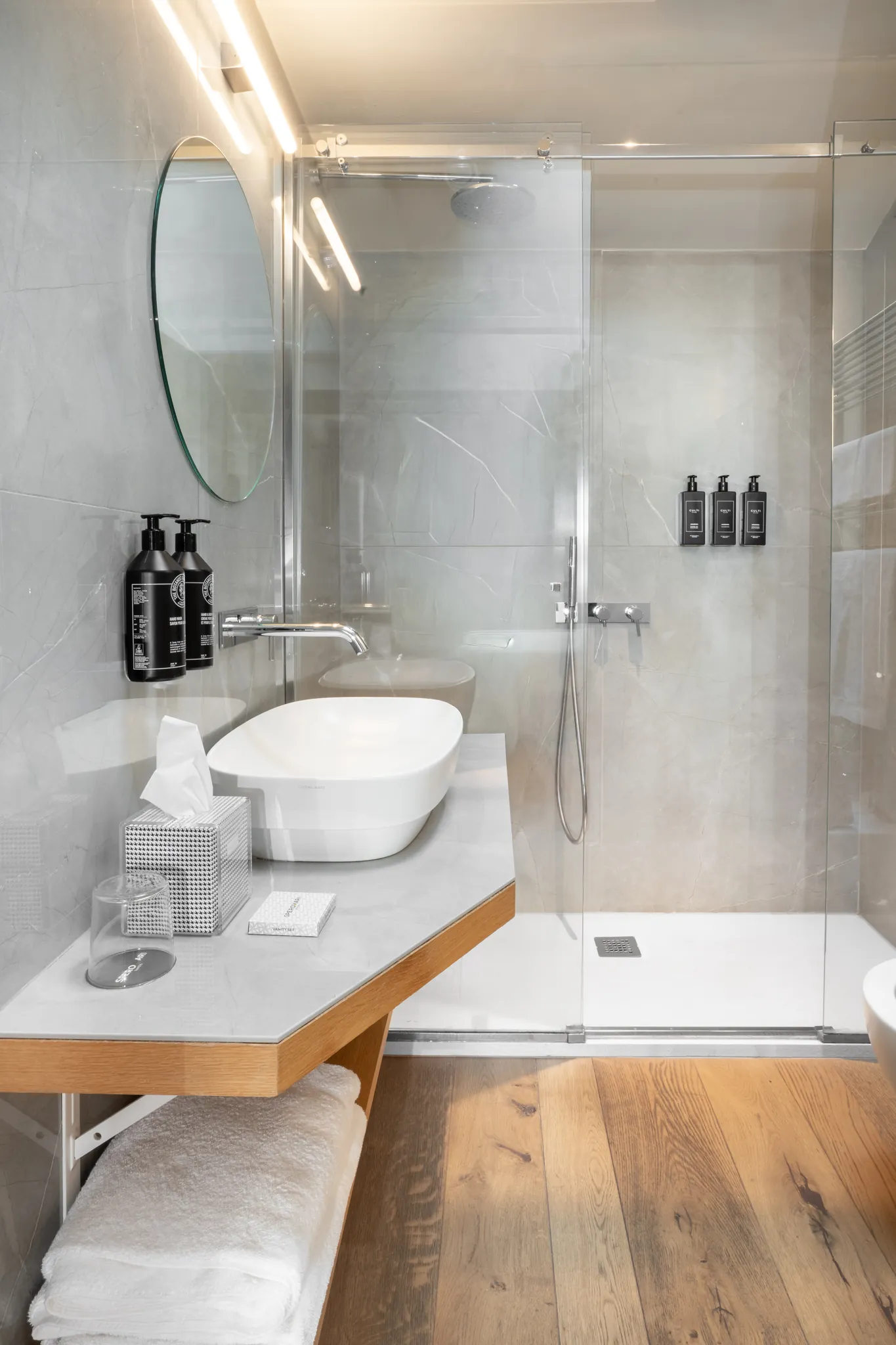 Bathroom — marble, brass, natural light, material warmth