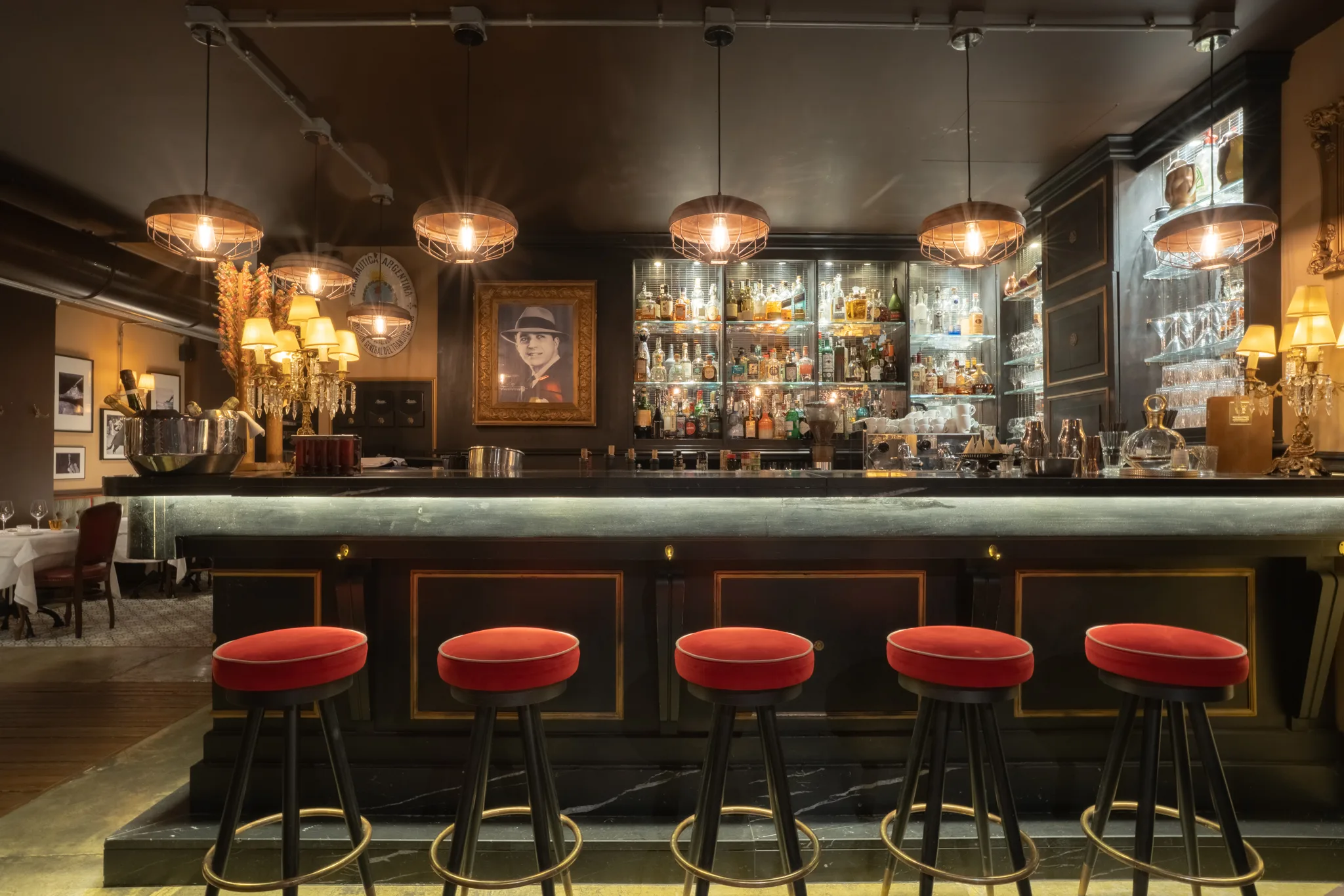 El Porteño bar — red velvet stools, brass, warm lighting